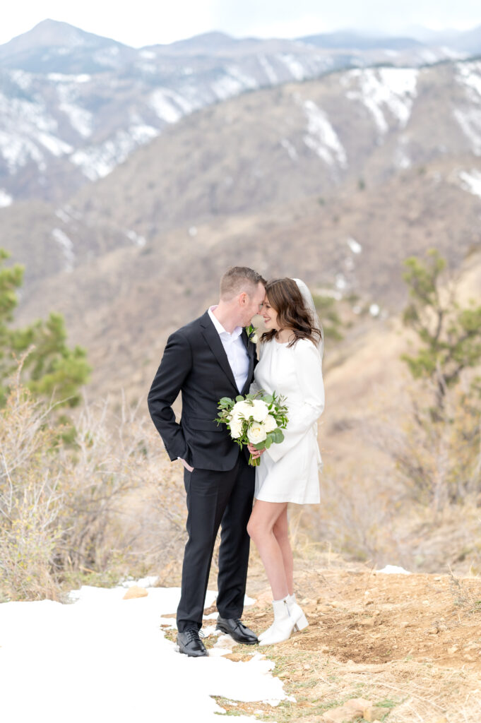 Bride and groom leaning their foreheads together and smiling to soak in the moment of getting married in the mountains in Colorado