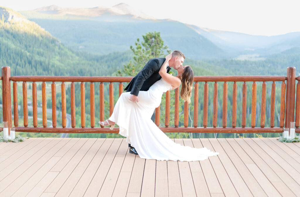 Newly married couple exchange a kiss on the Sky View Deck at The Lodge at Breckenridge in Colorado