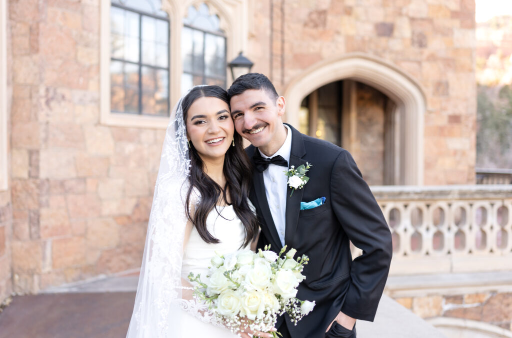 Bride and Groom smiling and laughing together to celebrate their elopement day at glen eyrie castle in Colorado Springs, Colorado