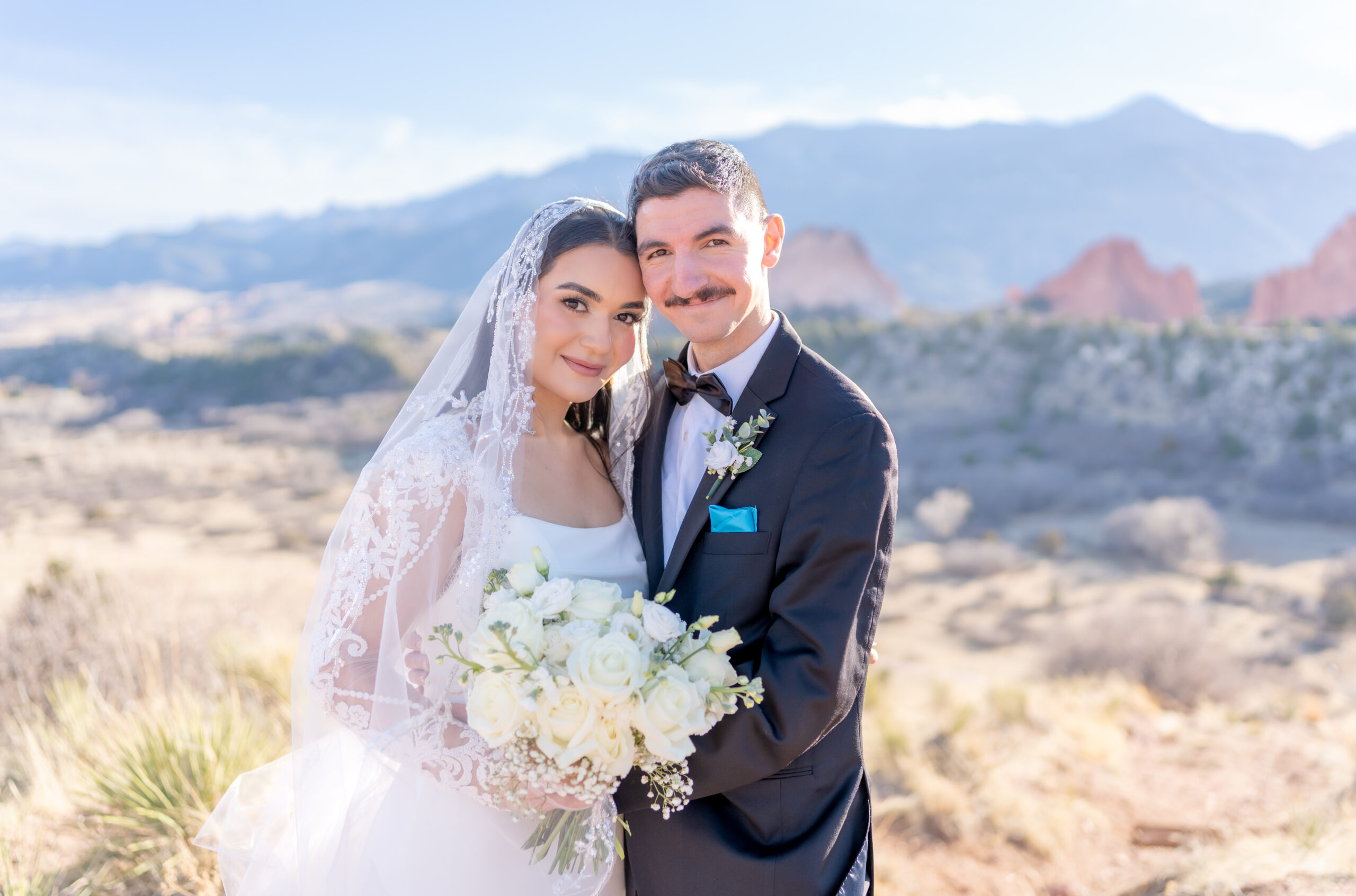 Couple leaning their heads together for a close hug celebrating their elopement in Colorado Springs