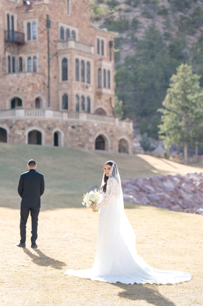 Bride and groom sharing their first look together on their elopement day at glen eyrie castle 