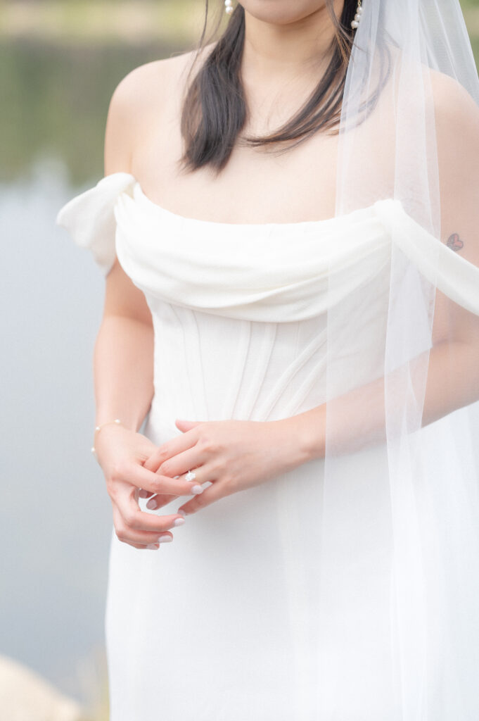 Closeup of bride's hands as she fingers her wedding ring