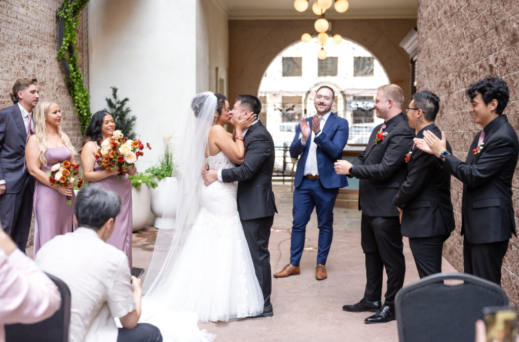 Bride and groom exchange a kiss after the wedding ceremony at the Mining Exchange Hotel in Colorado Springs