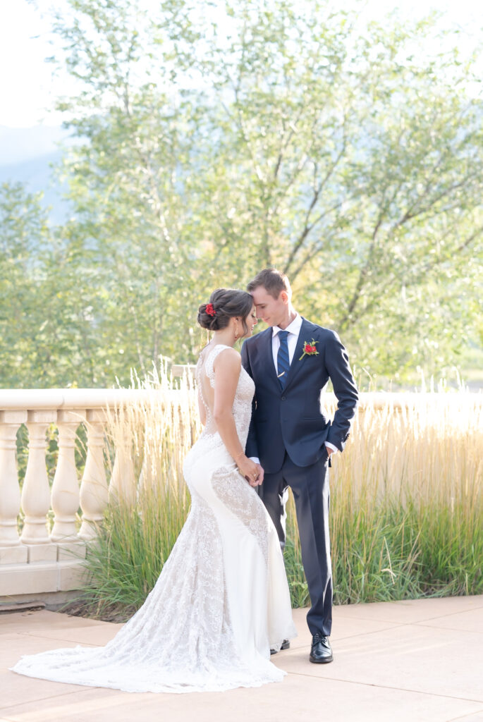 Bride smiling at groom during outdoor portraits at The Pinery At The Hill