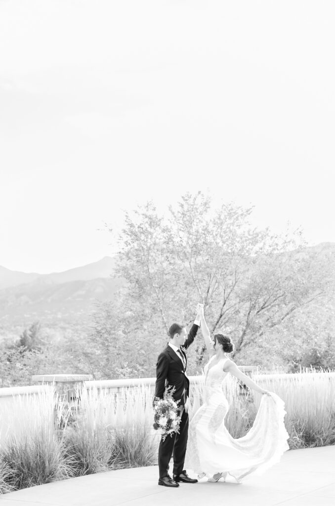 Groom holding bride's hand as she twirls her dress around at The Pinery at The Hill 