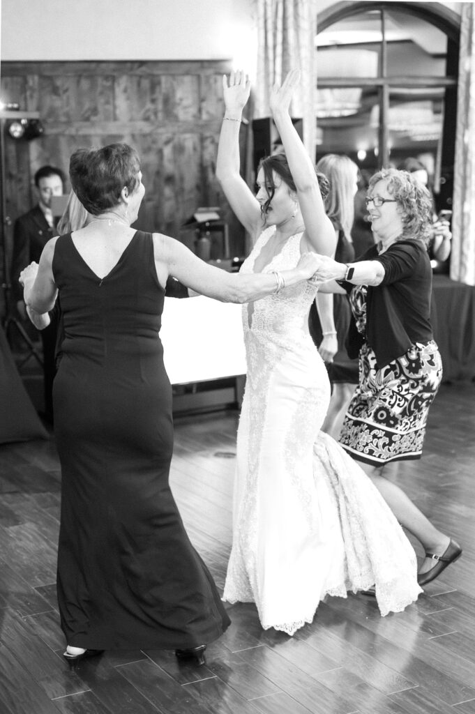 Open dance floor filled with wedding guests celebrating