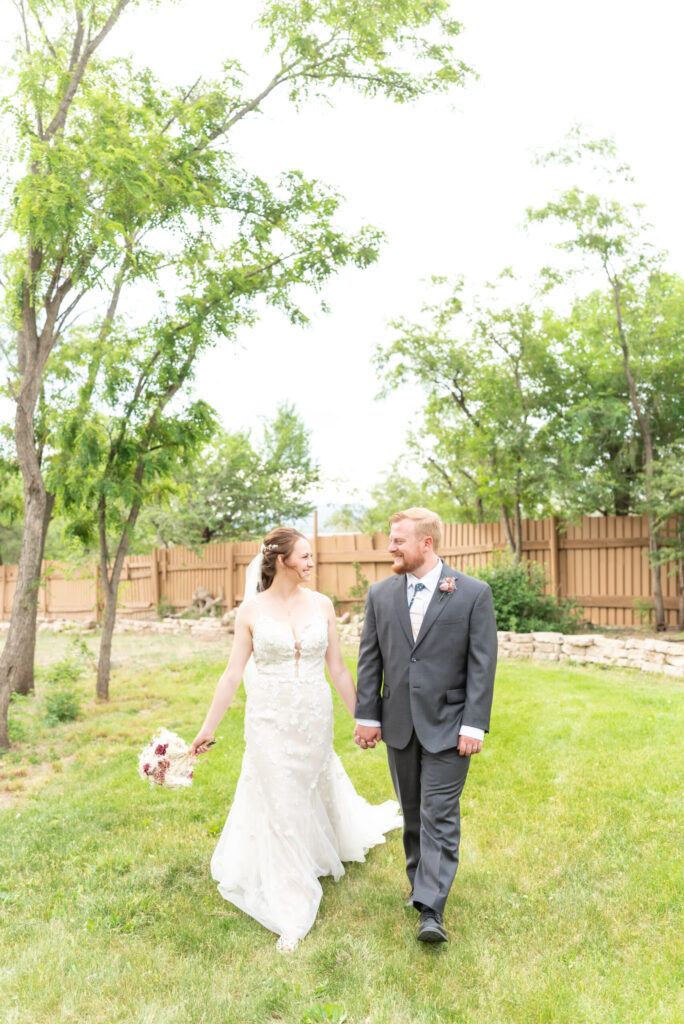 Couple walking through garden after wedding at Hillside Gardens, a micro wedding venue Colorado Springs. 