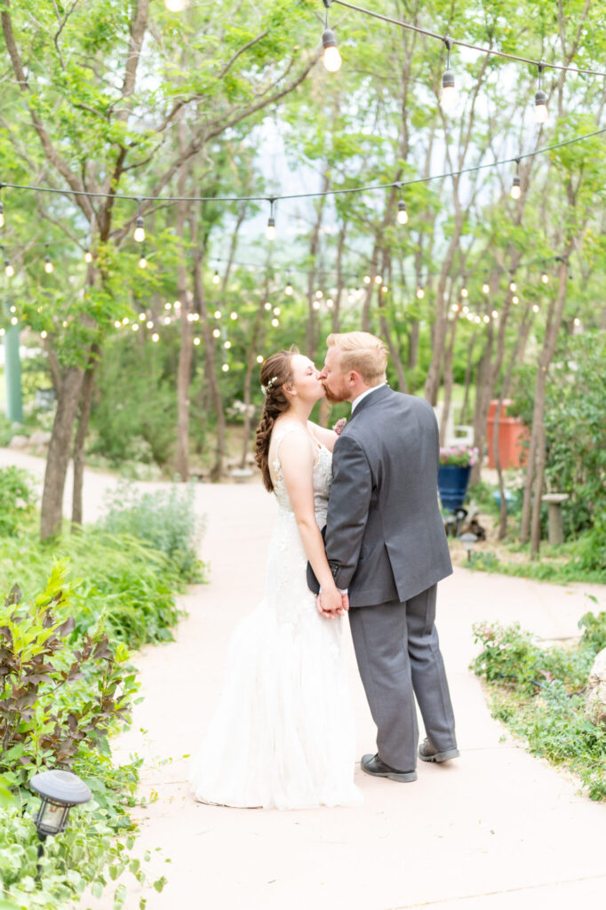 Couple kissing after Intimate garden wedding at Hillside Gardens, a micro wedding venue Colorado Springs. 