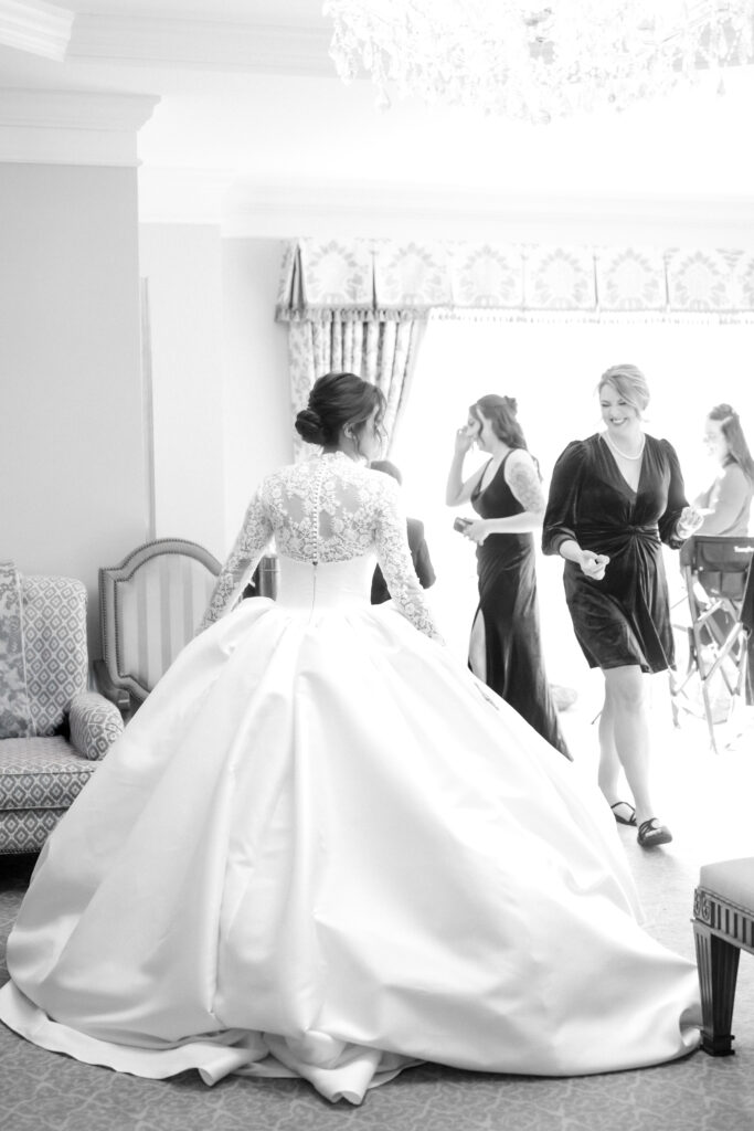 The bride is talking and laughing with her bridesmaids in her bridal suite at The Broadmoor wedding venue