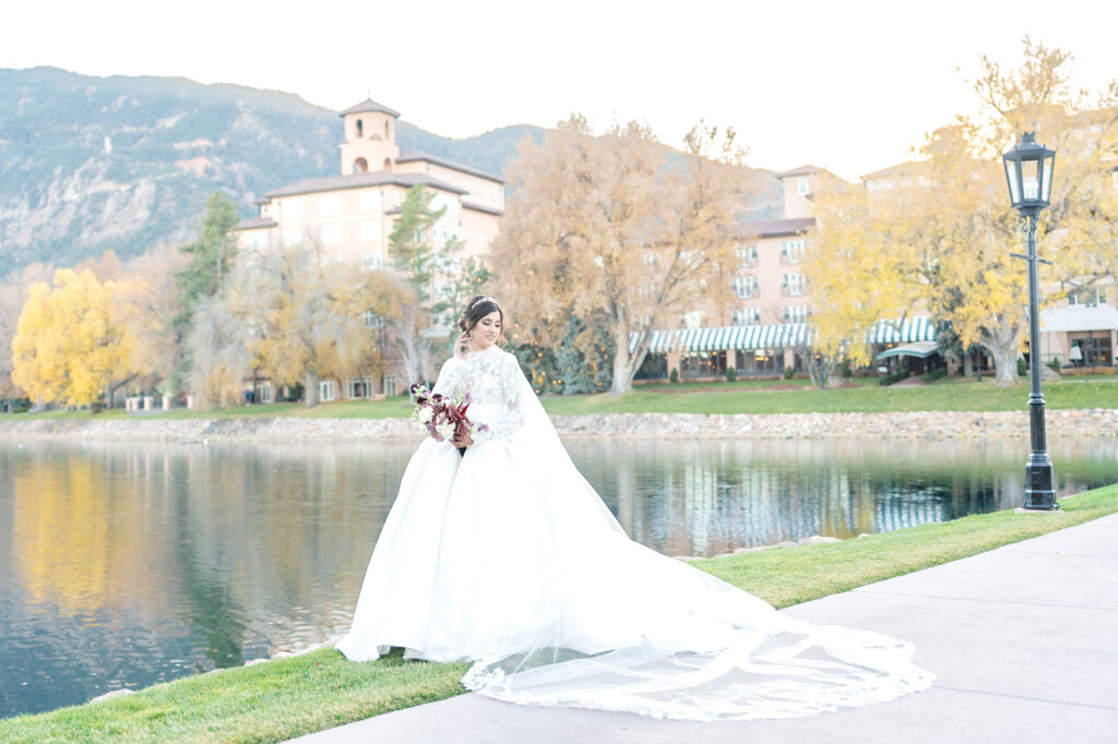 Landscape bridal portrait of the bride at the elegant venue The Broadmoor in Colorado Springs