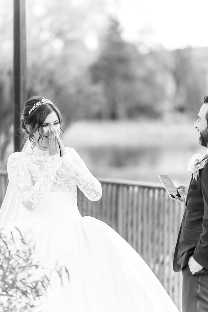 Bride laughing to share in a funny moment with her groom during their winter wedding ceremony, at The Broadmoor