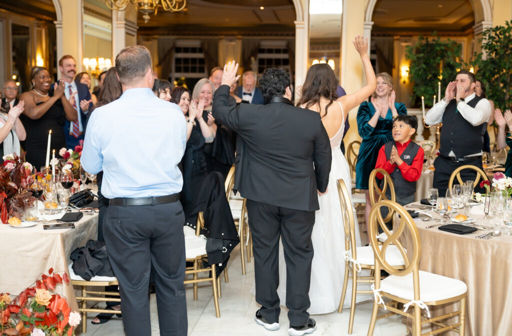 Bride and groom entering their reception as they are announced mr and mrs, at The Broadmoor wedding venue 