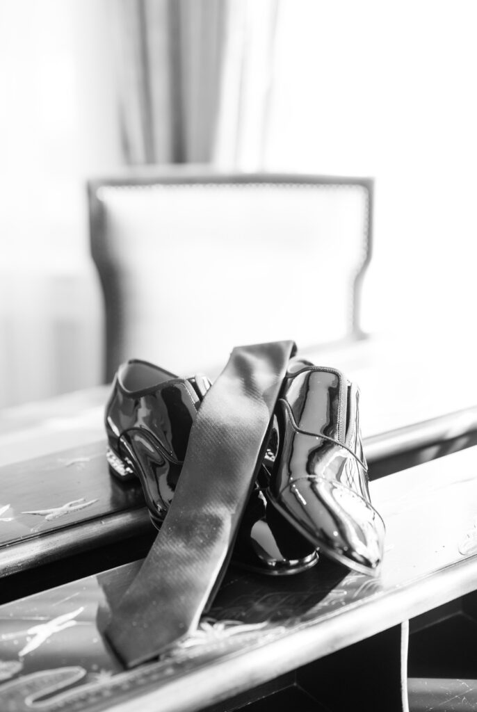 Black and white detail photo of the groom's black leather dress shoes for a winter wedding at The Broadmoor 