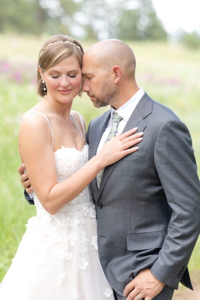 bride and groom sharing and intimate moment during their portrait session at their outdoor wedding in colorado springs