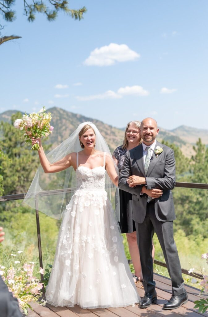 bride and groom celebrating getting married at their outdoor wedding venue in colorado springs