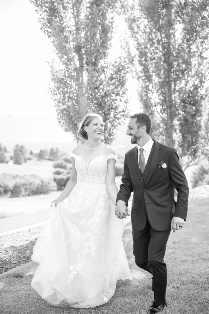 bride and groom walking hand in hand during their portait photo session at their flying horse resort colorado springs wedding