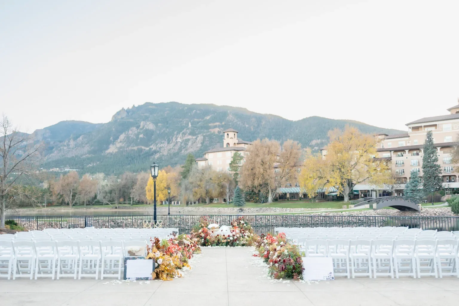 wedding aisle and chairs with stunning mountain view in the background at the broadmoor, a colorado springs outdoor wedding venue