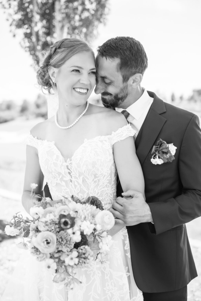 bride and groom sharing an intimate moment during their portait session at their colorado springs outdoor wedding