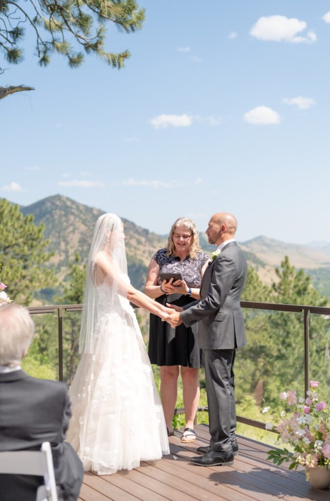 bride and groom exchanging vows during their colorado springs outdoor wedding