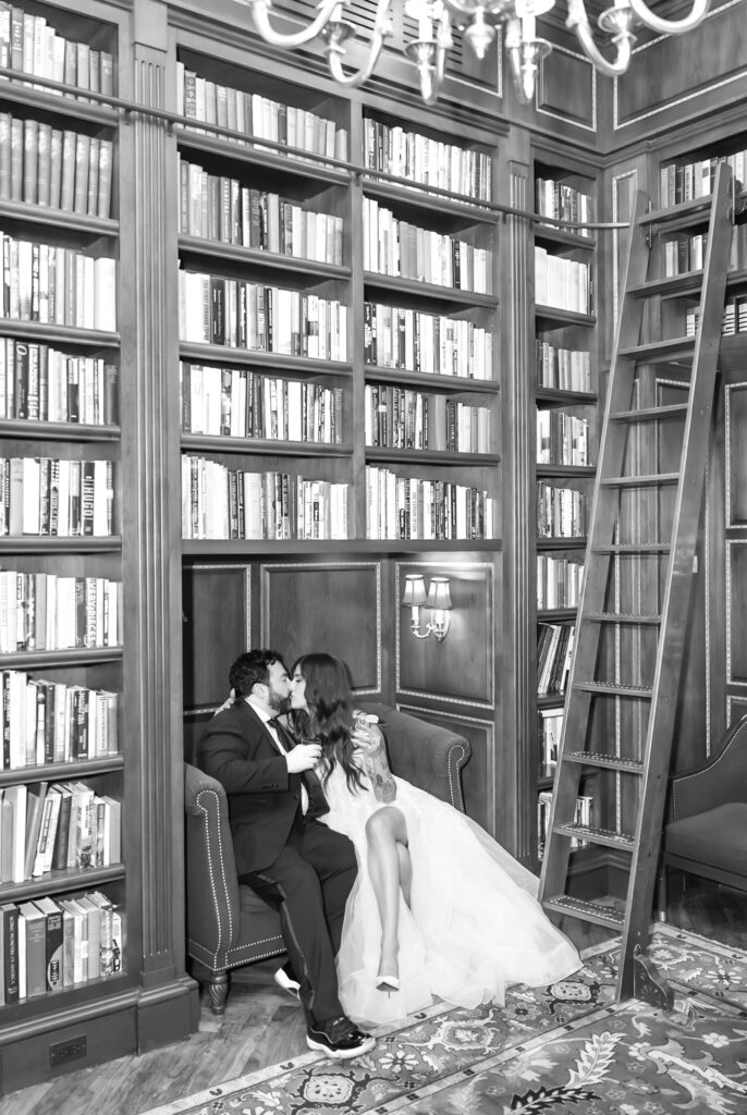 Bride and groom sharing a kiss for a editorial moment in the library, at The Broadmoor venue, in Colorado Springs
