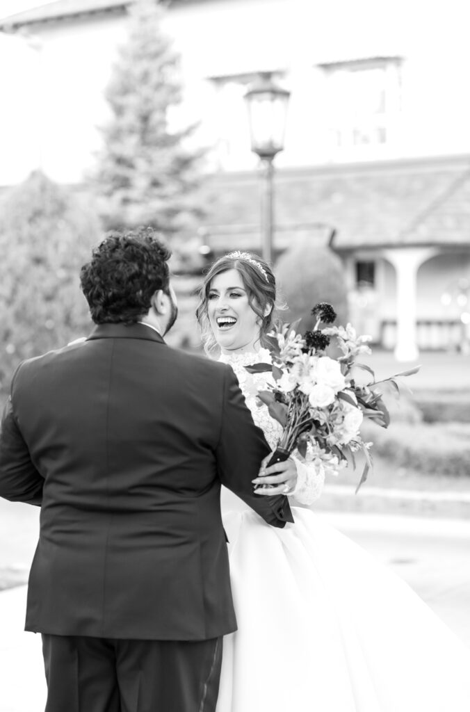 Bride laughing and smiling at her groom during their wedding first look at The Broadmoor wedding venue in Colorado Springs
